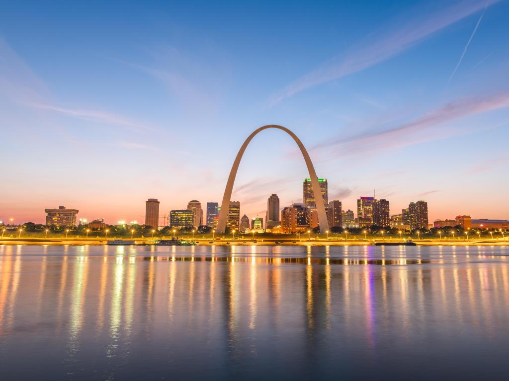 St. Louis, Missouri, USA downtown cityscape with the arch and courthouse at dusk.