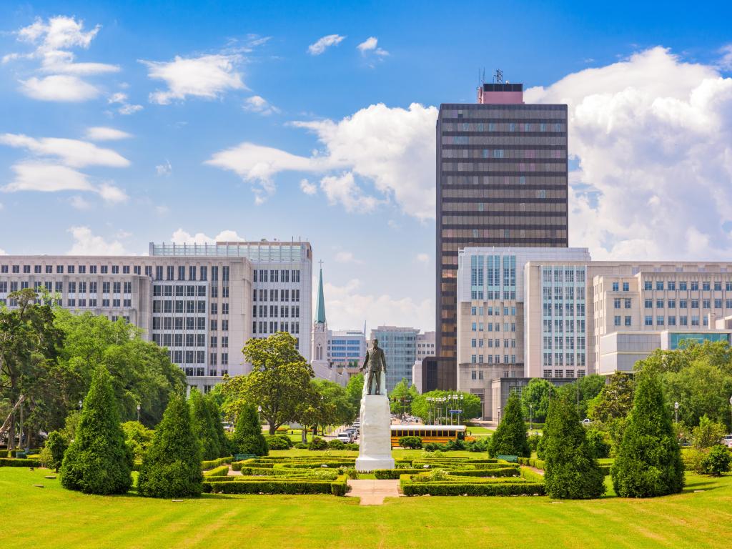 Baton Rogue, Louisiana, USA with the Huey Long memorial and the downtown Baton Rouge skyline taken on a sunny day.