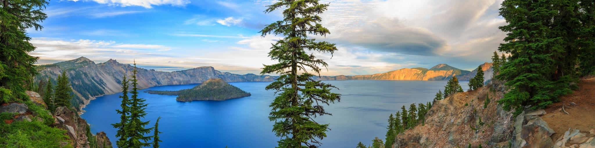 View of Crater Lake, Oregon, with trees in the foreground.