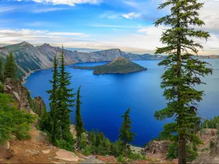View of Crater Lake, Oregon, with trees in the foreground.