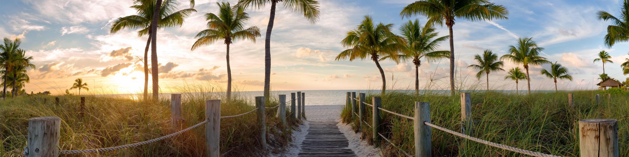 Panorama view of footbridge to the Smathers beach at sunrise - Key West, Florida, USA.