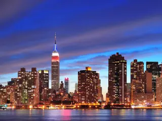 Illuminated high rise buildings of New York City skyline, taken from across the river