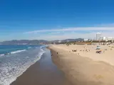A panorama picture of the Santa Monica State Beach, with waves lapping against sandy shore