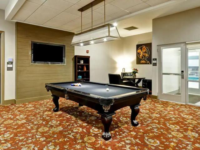 Games room at Hyatt House Atlanta Cobb Galleria, with large pool table, television and seating area