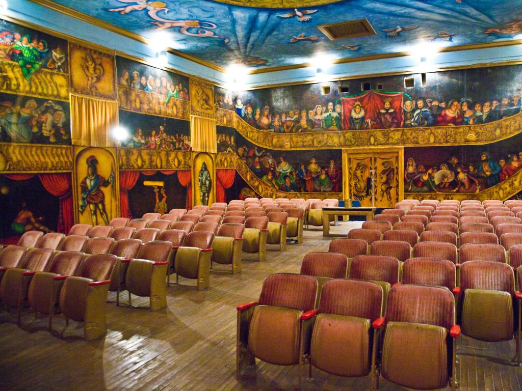 Inside the beautiful Amargosa Opera House, with painted actors and characters on the walls