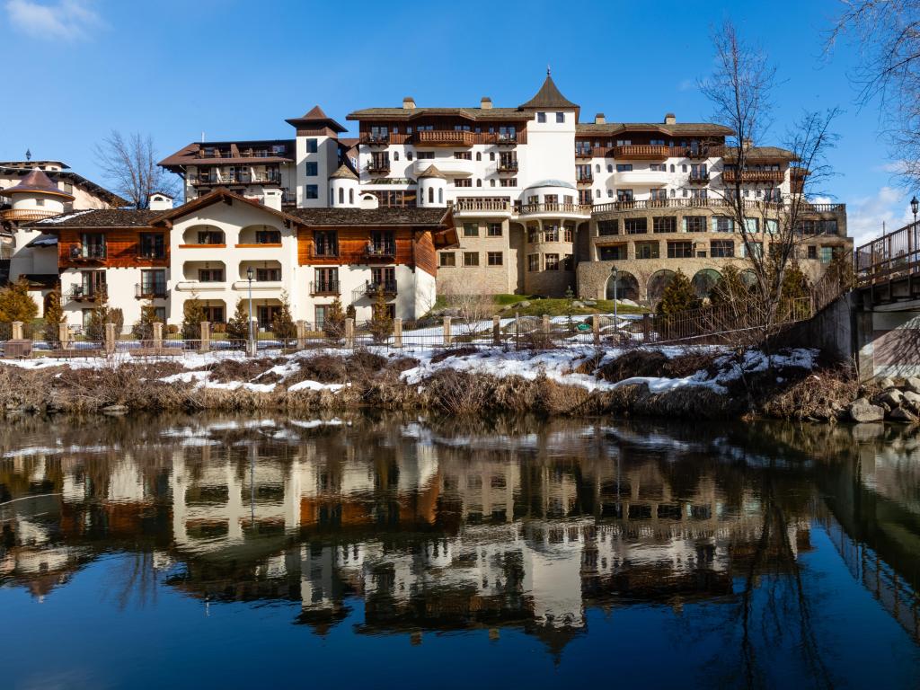 Leavenworth, Washington, USA, February 1, 2020, View of Posthotel with reflection in river, from Enchantment Park.