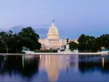 United States Capitol building in Washington DC, with the Capitol Reflecting Pool in the foreground, at dusk