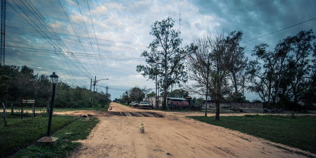 A muddy cross roads with a streetlight to one side in the town of Colonia Carlos Pellegrini, Argentina