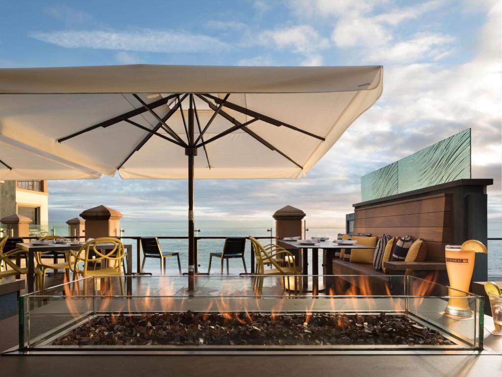 Rooftop lounge with fire pit and sea views at Monterey Plaza Hotel