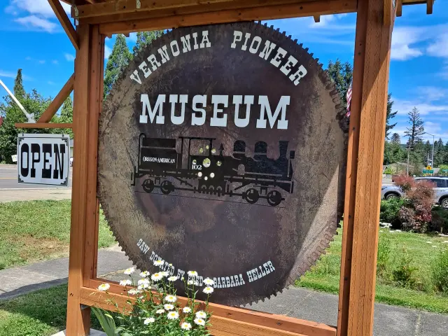 Museum's entrance sign, a circular saw with "Vernonia Pioneer Museum" written on it in white