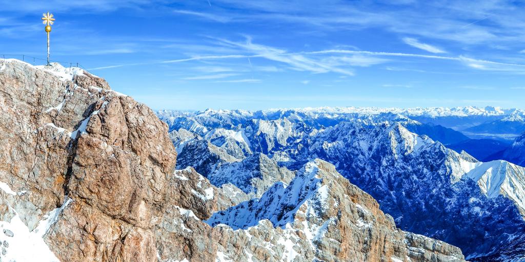 The brown granite peak at Zugspitze with many snow capped mountain peaks in the background