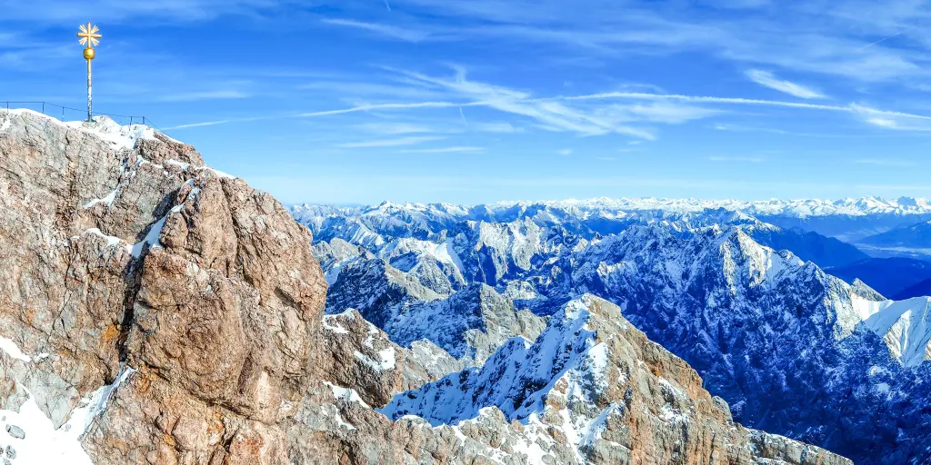The brown granite peak at Zugspitze with many snow capped mountain peaks in the background