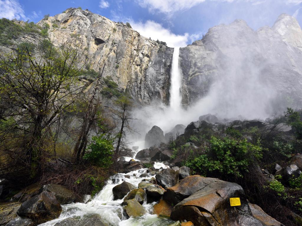 View of the waterfall from the ground below, sunny day in Yosemite National Park