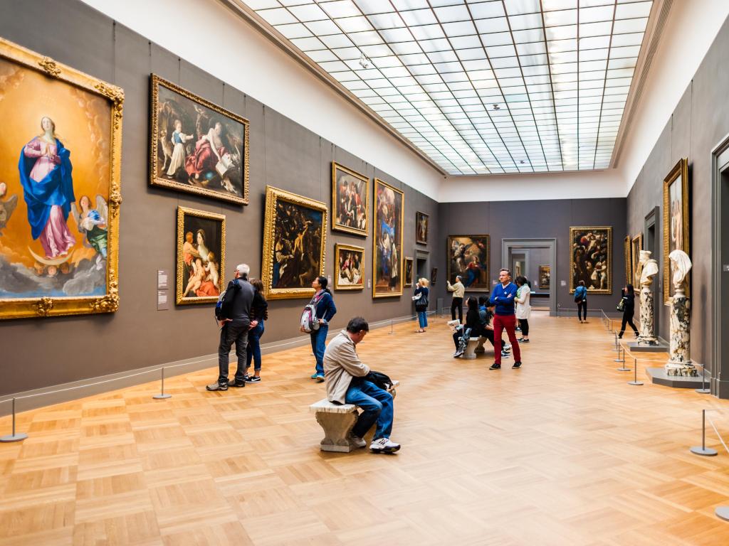 People looking at paintings in the Metropolitan Museum of Art, New York