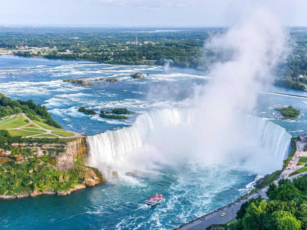 Aerial view Niagara Falls, with gushing waters and boat approaching falls, Canadian Falls, Canada