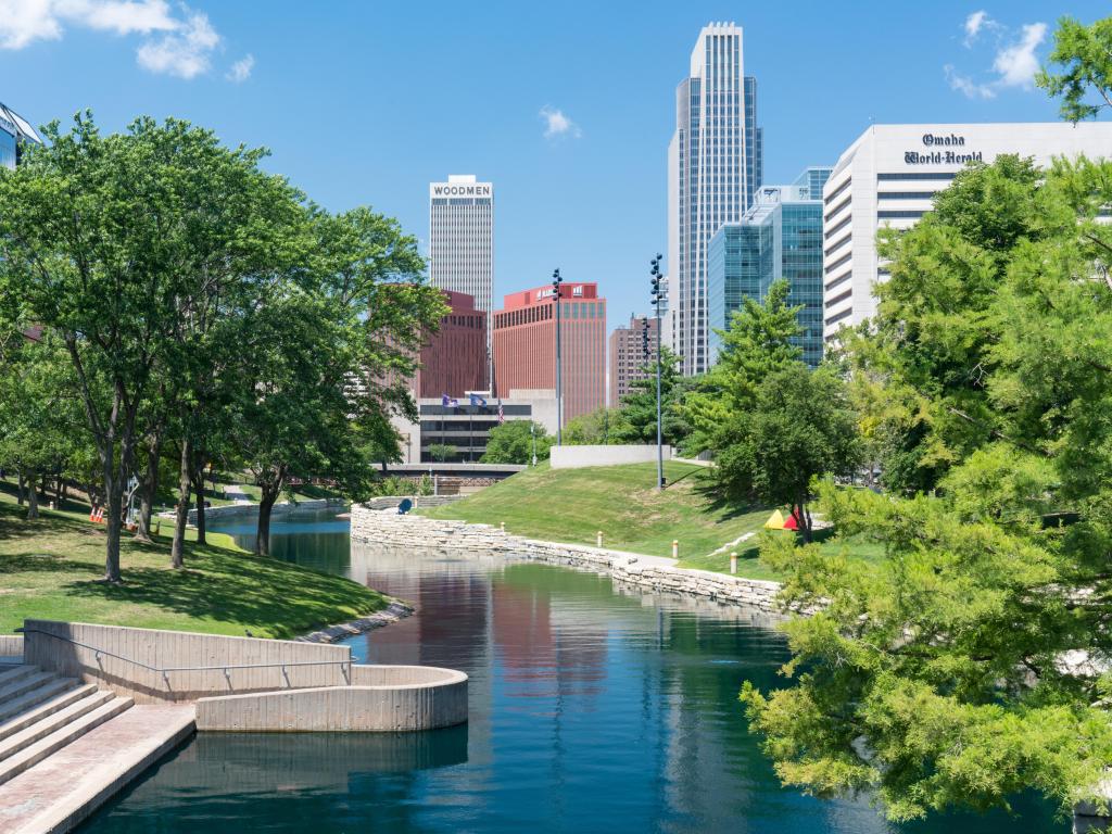 City Skyline in Downtown Omaha, Nebraska along the Gene Leahy Mall with the Missouri River running in the middle.