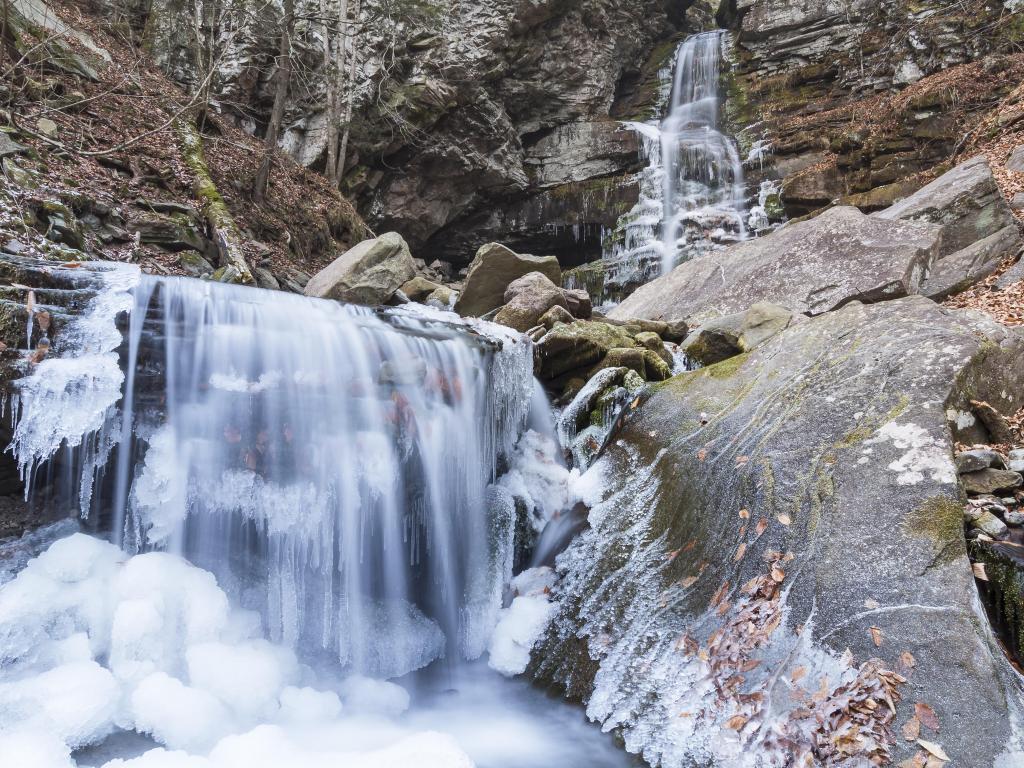 Partially frozen Buttermilk Falls spills into Peekamoose Gorge on a chilly late November day in the Catskills Mountains on New York