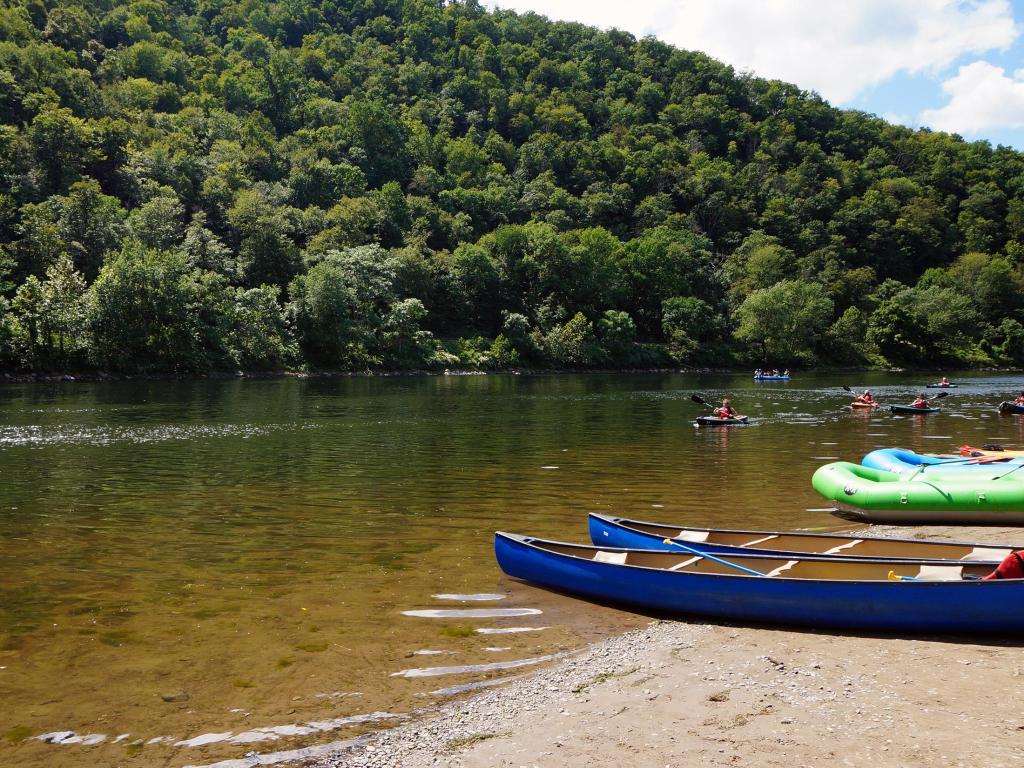 Kayakers in the Delaware River and Canoes and Rafts on the Shore at the Delaware Water Gap in Pennsylvania