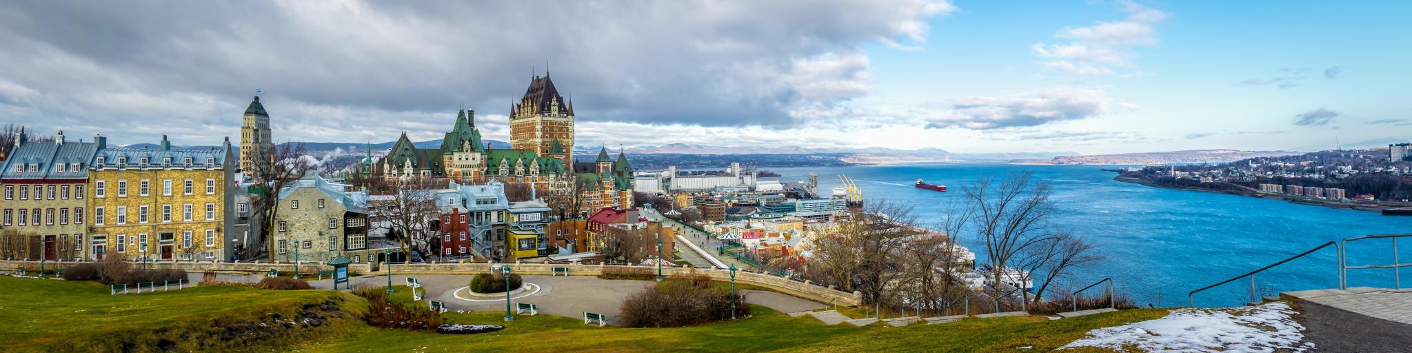 Quebec City, Quebec, Canada taken as a panoramic view of Quebec City skyline with Chateau Frontenac and Saint Lawrence river in winter.