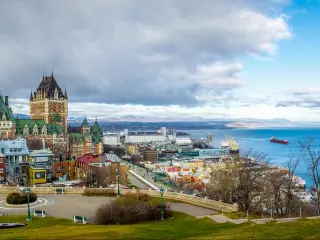 Quebec City, Quebec, Canada taken as a panoramic view of Quebec City skyline with Chateau Frontenac and Saint Lawrence river in winter.