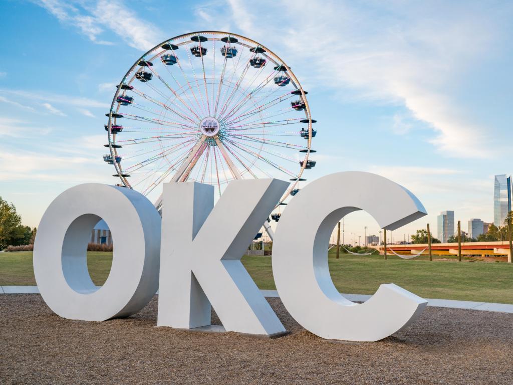 Skyline of Oklahoma City, OK with OKC sign and ferris wheel.