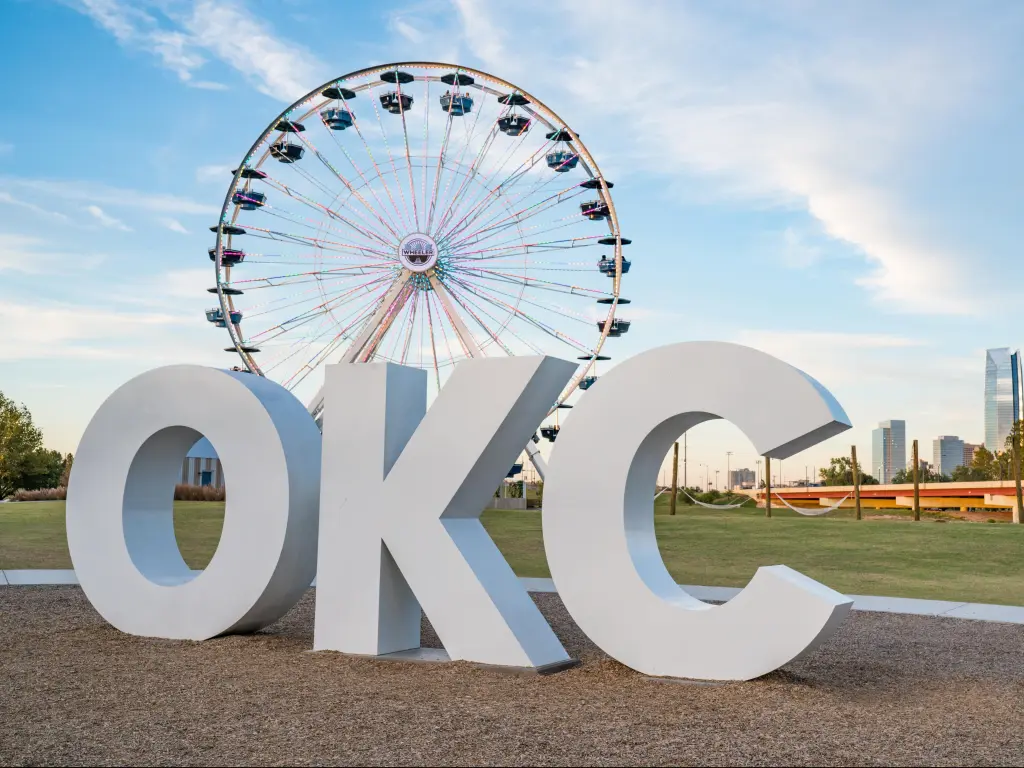 Skyline of Oklahoma City, OK with OKC sign and ferris wheel.