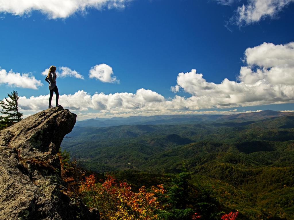Female hiker admiring the panoramic view across Blowing Rock in North Carolina, USA