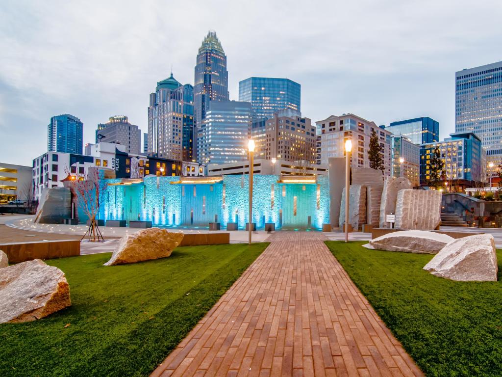 Charlotte, North Carolina, USA with the city skyline in the distance and a sculpture park in the foreground taken at early evening.
