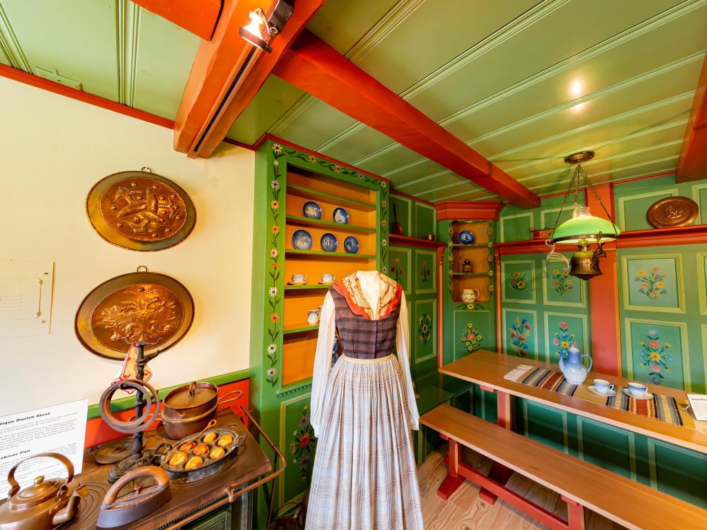 Interior of the museum with a traditional Danish outfit on display and replicas of food items