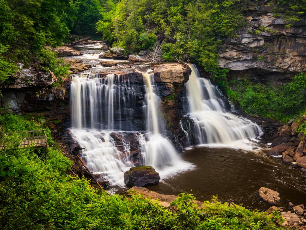 Blackwater River State Forest, West Virginia, USA taken at Elakala waterfall in Blackwater Falls state park in West Virginia in fall autumn season with colorful leaves foliage over bridge and swirling pool stream unique nature