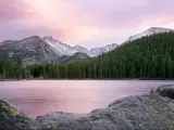 Rocky Mountain National Park, Colorado, USA taken at sunset at Bear Lake, with trees and mountains in the distance.