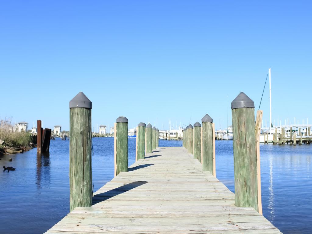 A view of a wooden dock with a blue sky in Gulfport, Mississippi