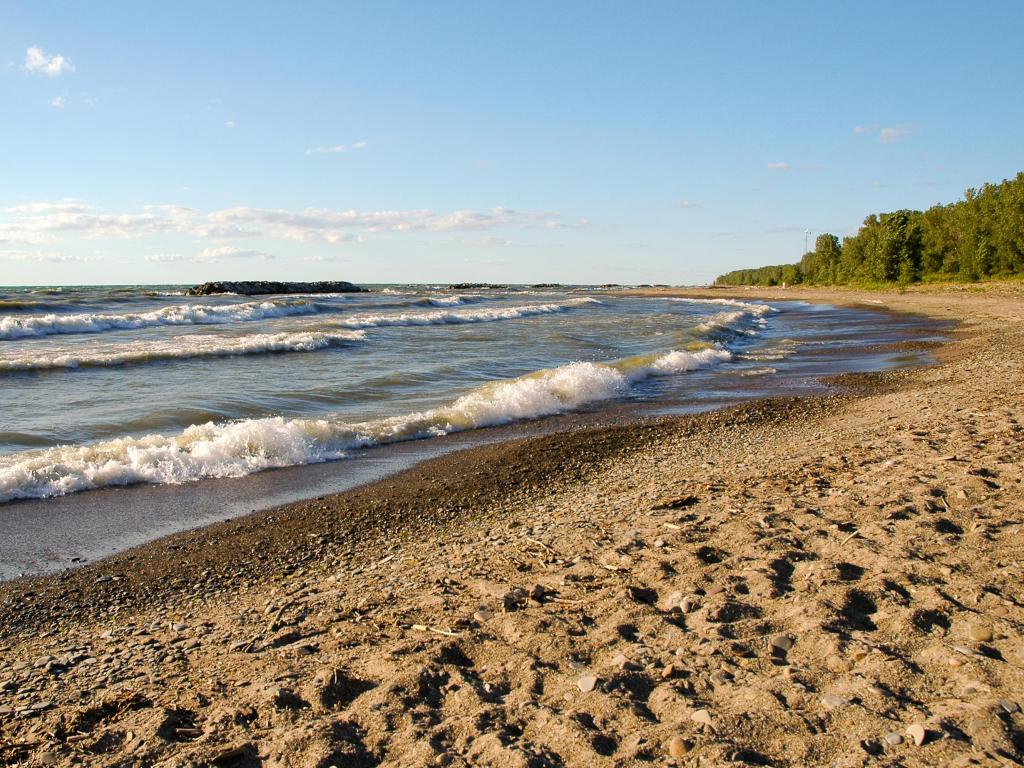 Waves crushing on the sandy banks of Lake Erie Beach on a sunny day