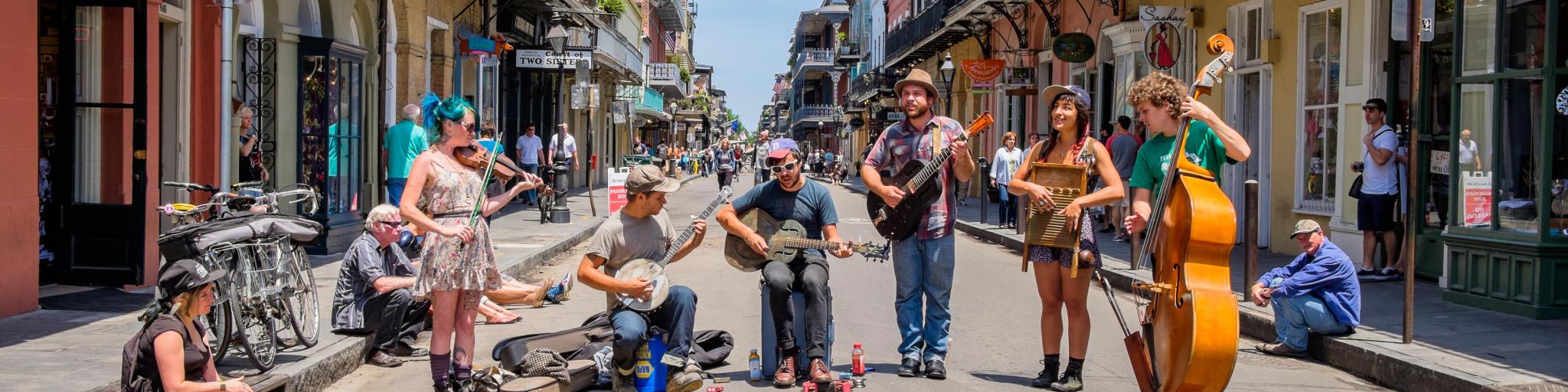 Street performers playing blue grass style music in the French Quarter district in New Orleans on a sunny day