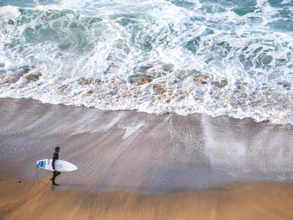 Man with a surf board in Torquay, Australia 