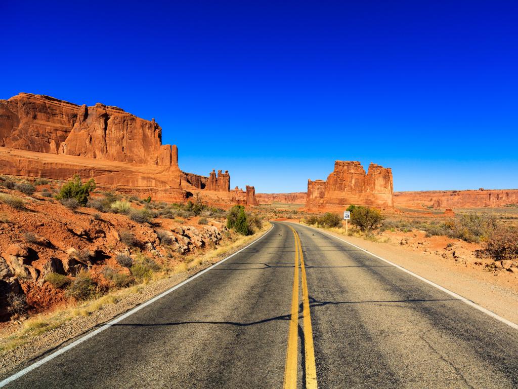 Road leading to the national park on a sunny day with bright blue sky