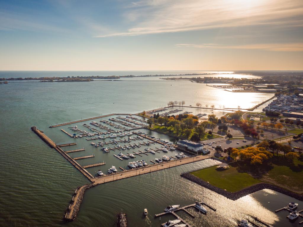 Boats sit docked in a harbor on Lake Erie on a sunny autumn morning