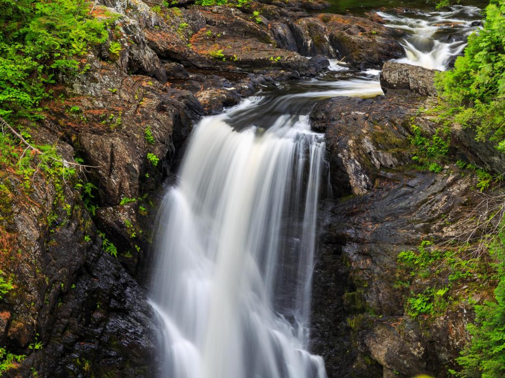 Waterfall with lush greenery around at Moxie Falls, Maine