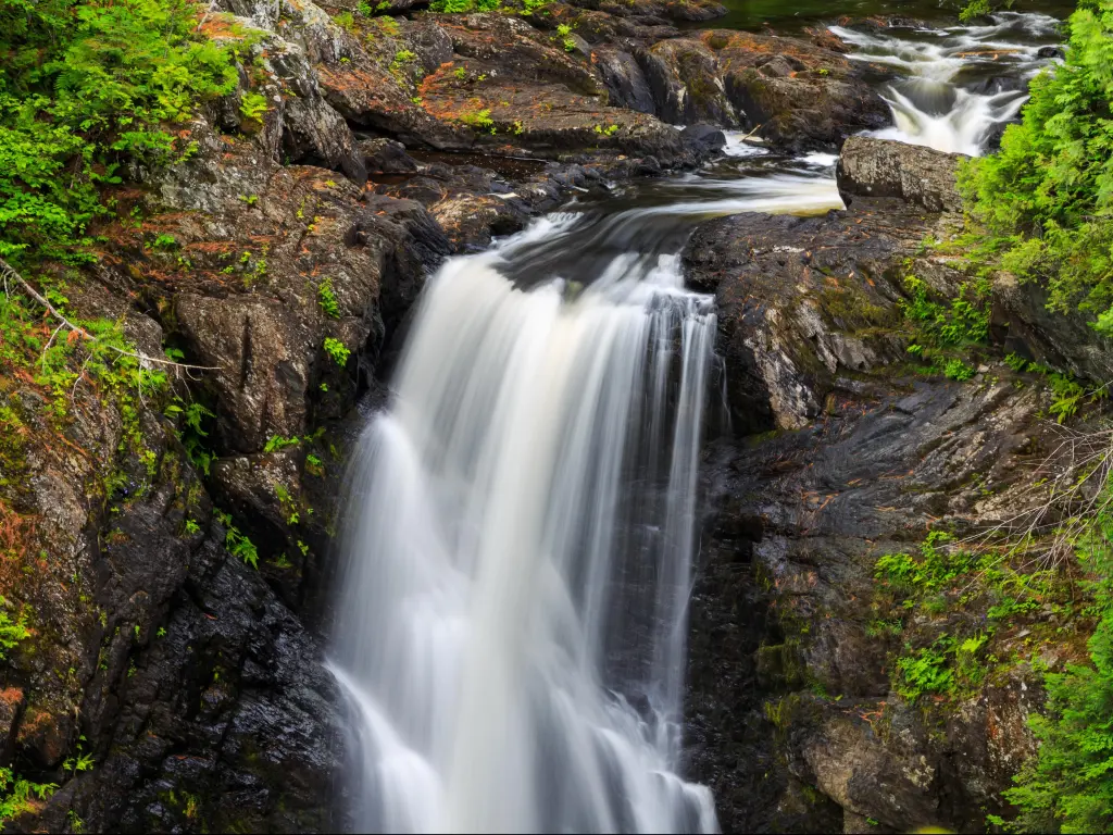 Waterfall with lush greenery around at Moxie Falls, Maine