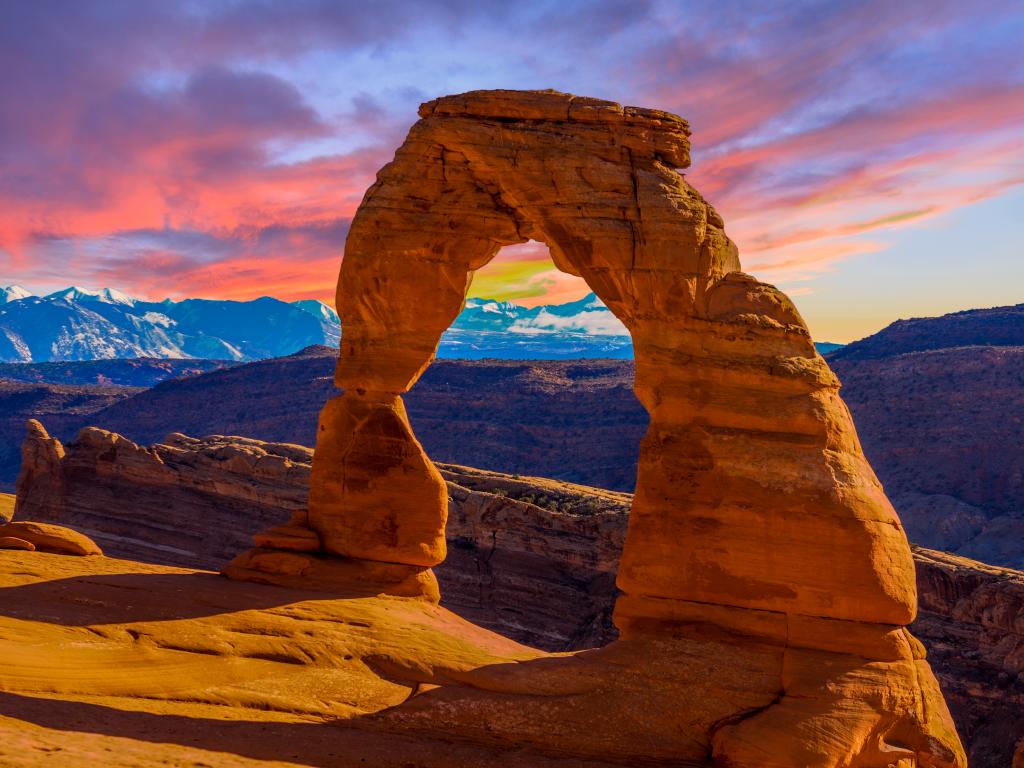 An image of a sandstone arch at Arches National Park during sunset.