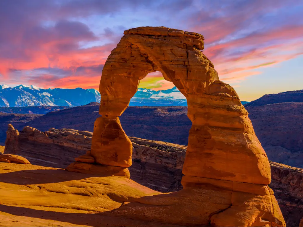 An image of a sandstone arch at Arches National Park during sunset.