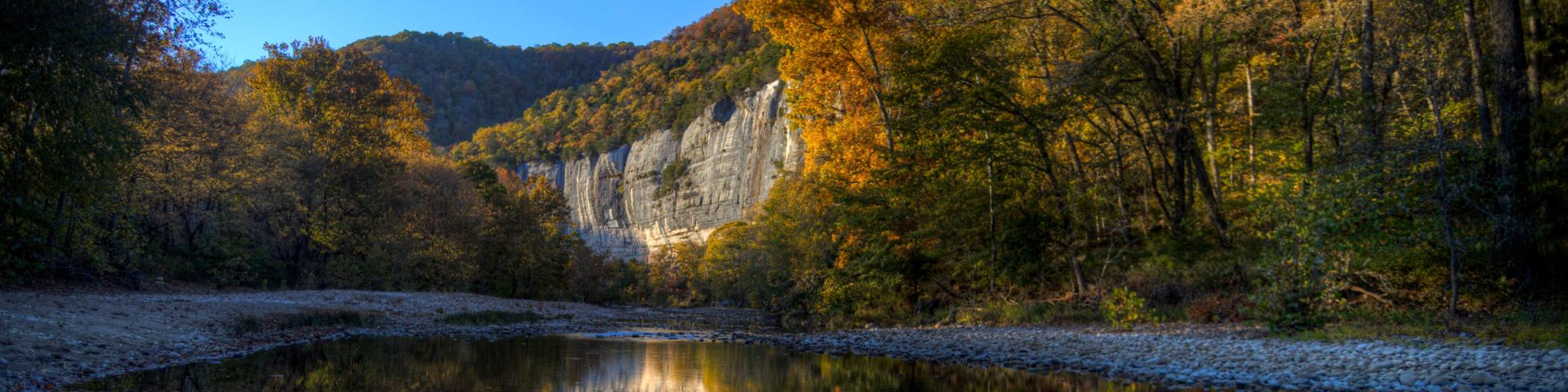 Sunset photo during the autumn as the trees change color at Roark Bluff in Steel Creek Campground along the Buffalo River located in the Ozark Mountains, Arkansas, USA.