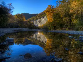 Sunset photo during the autumn as the trees change color at Roark Bluff in Steel Creek Campground along the Buffalo River located in the Ozark Mountains, Arkansas, USA.