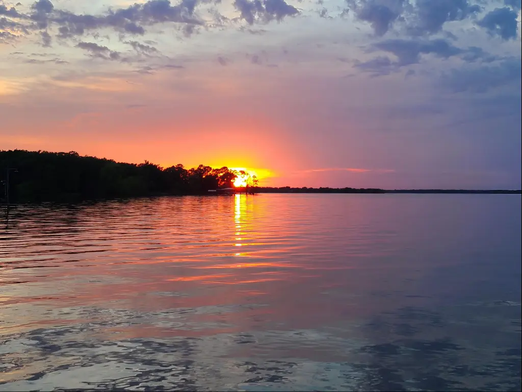 Lake Tawakoni, Texas, USA taken at sunset with trees in the distance.