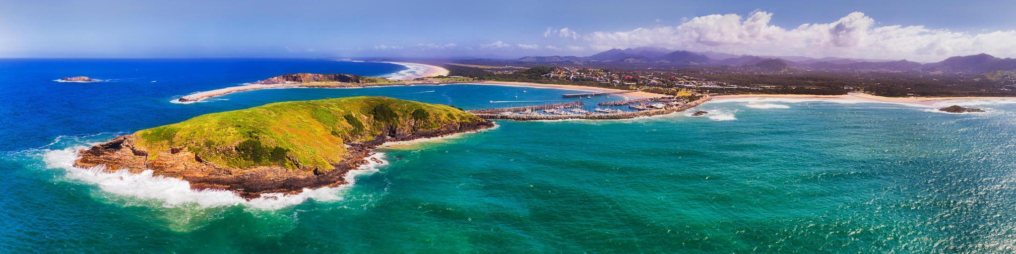Coffs Harbour, Australia showing Muttonbirds Island and the Marina in the distance with sandy beaches on a sunny day.