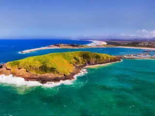 Coffs Harbour, Australia showing Muttonbirds Island and the Marina in the distance with sandy beaches on a sunny day.