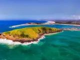 Coffs Harbour, Australia showing Muttonbirds Island and the Marina in the distance with sandy beaches on a sunny day.