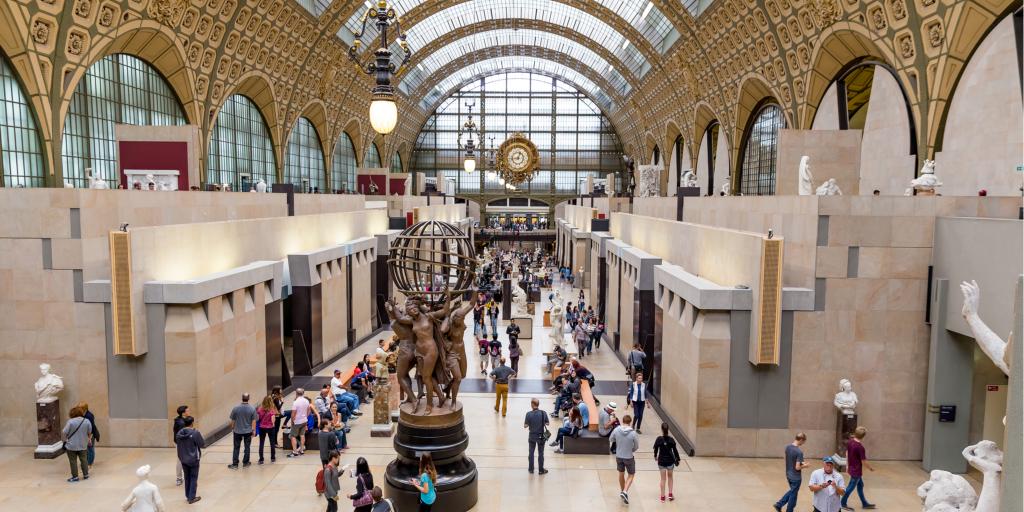 People walking around inside the Musee D'Orsay in Paris