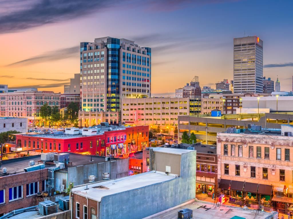 Memphis, Tennessee, USA city skyline over Beale Street at dusk.