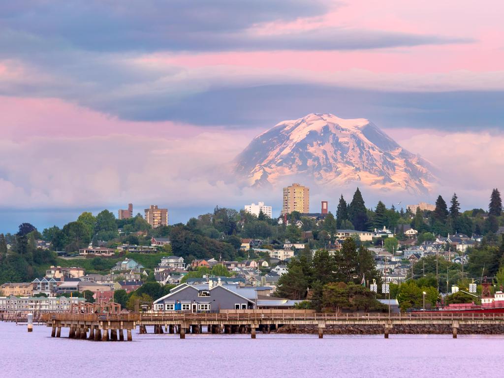 Tacoma, Washington, USA with Mount Rainier in the distance over Tacoma Washington waterfront during alpenglow sunset evening.